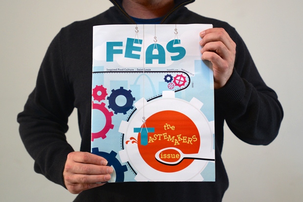 Feast Magazine Cover held by a designer at Atomicdust