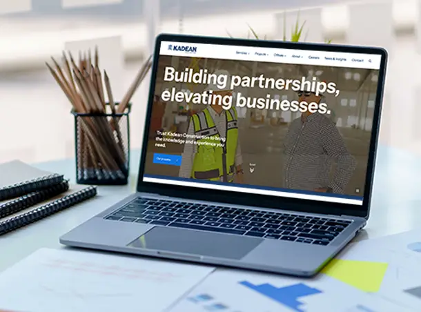 Kadean commercial construction website homepage on a laptop