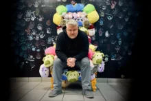Mike Spakowski, Atomicdust founder and 2026 St. Louis TITAN 100 honoree, sits on a throne made of stuffed animals