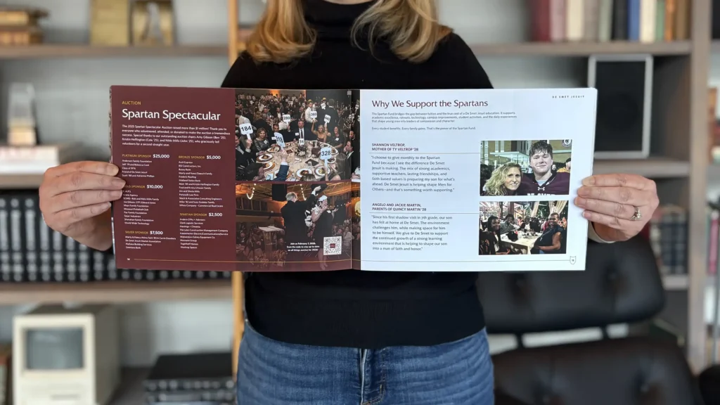 An Atomicdust team member holds the De Smet annual report
