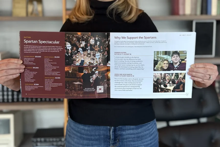 An Atomicdust team member holds the De Smet annual report