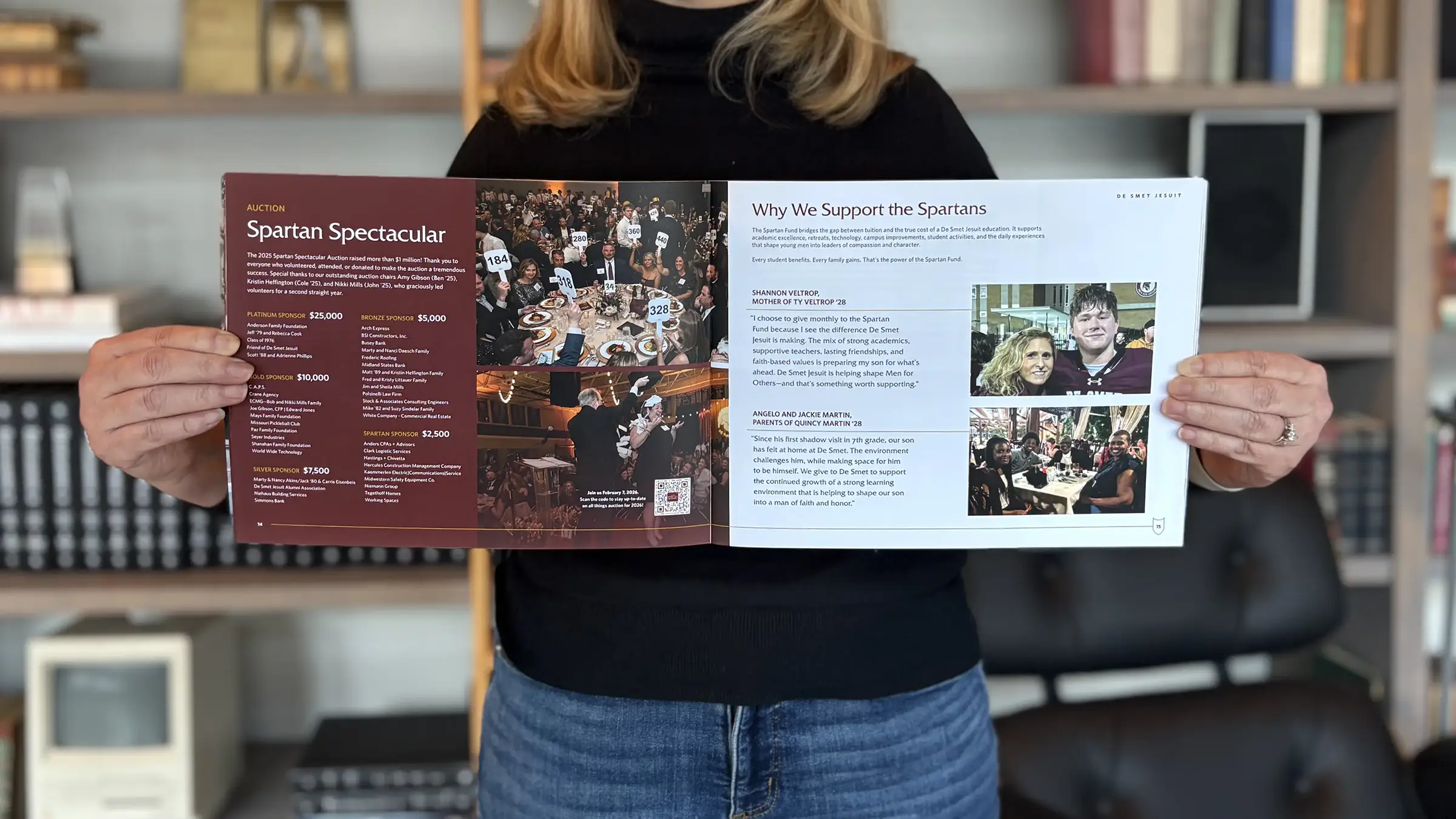 An Atomicdust team member holds the De Smet annual report