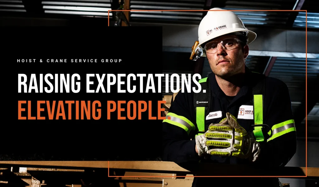 Hoist & Crane team member at a work site with the words "Raising expectations. Elevating people."