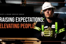 Hoist & Crane team member at a work site with the words "Raising expectations. Elevating people."