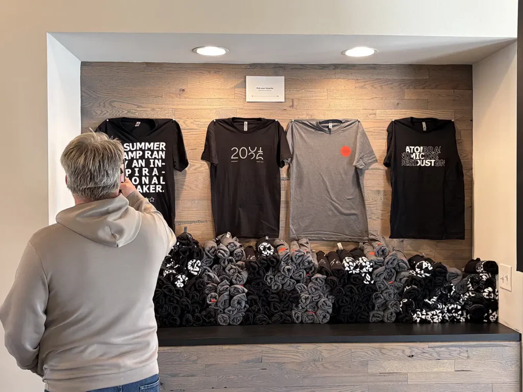 Mike takes a photo of Atomicdust t-shirts given away at the 25th anniversary party
